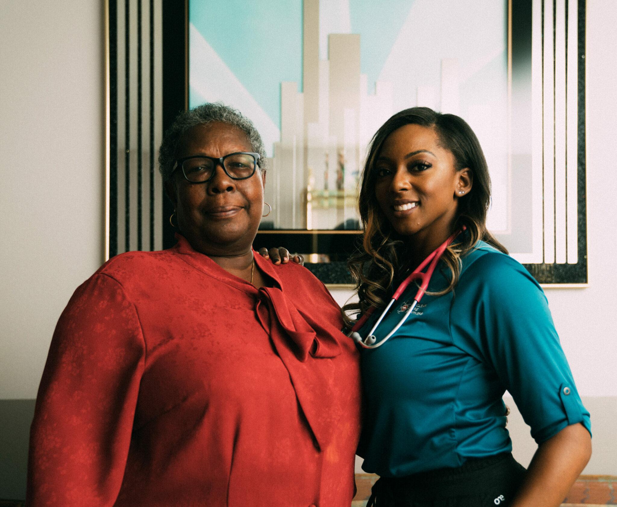 smiling young nurse and elderly woman young nurse and elderly woman smiling